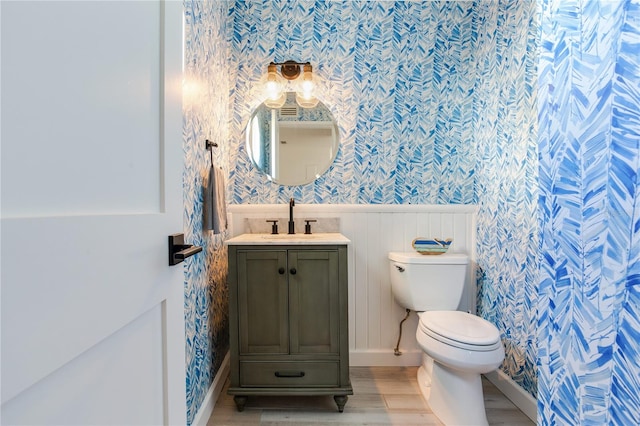 bathroom featuring hardwood / wood-style flooring, vanity, and toilet