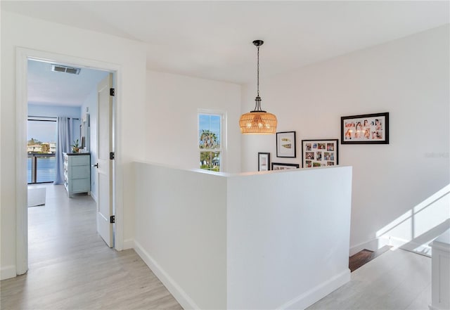 hallway with light hardwood / wood-style flooring