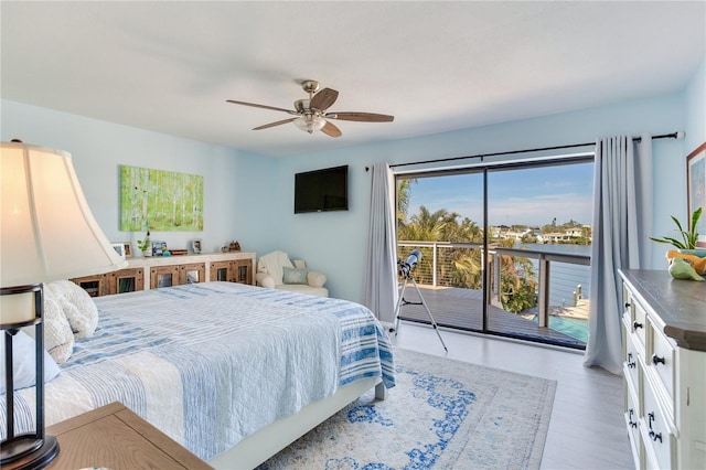 bedroom with light wood-type flooring, access to outside, and ceiling fan