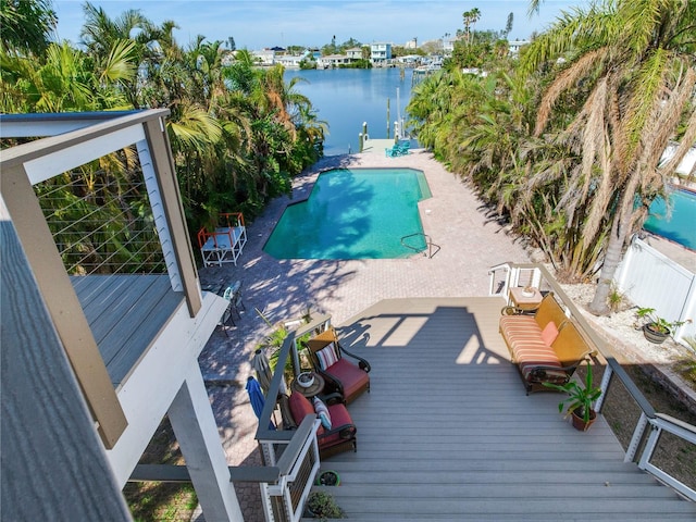 view of swimming pool with a deck with water view