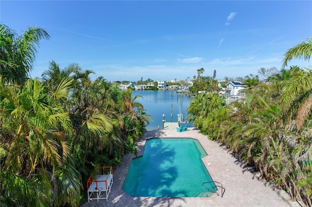 view of swimming pool with a patio area and a water view