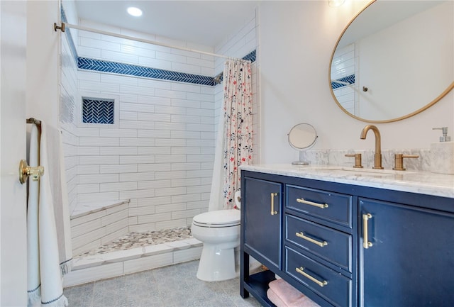 bathroom featuring a shower with shower curtain, vanity, and toilet