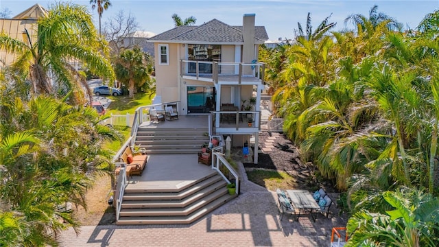 exterior space with a patio area, a balcony, and a deck