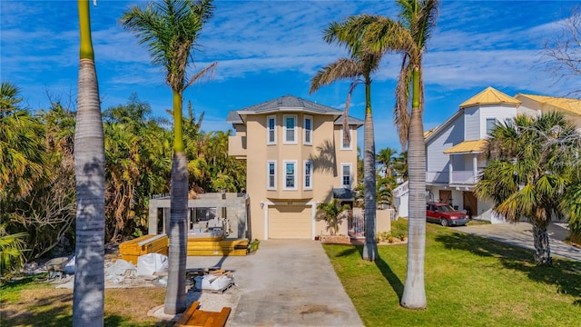 view of front facade with a garage and a front yard