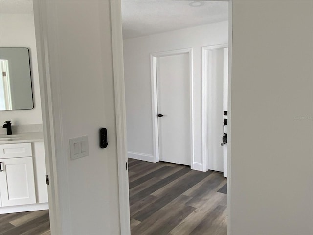 hallway with sink and dark hardwood / wood-style floors