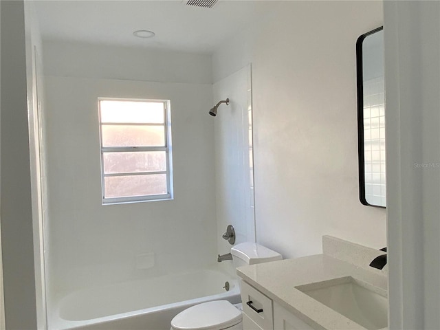 full bathroom with toilet, vanity, and tiled shower / bath