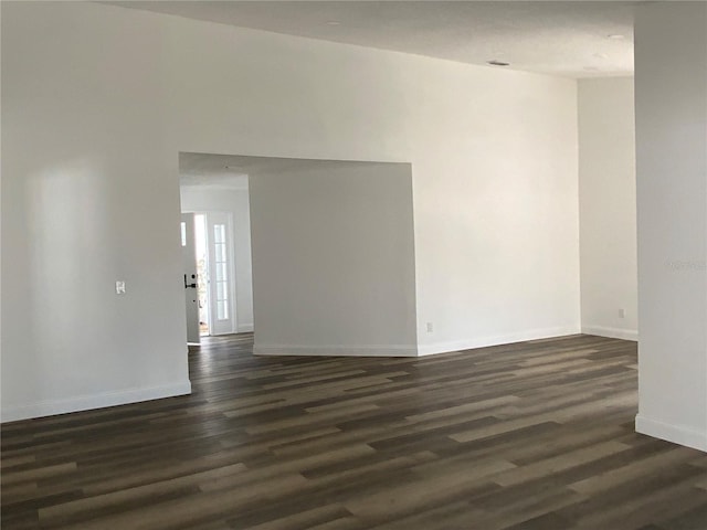 spare room featuring dark hardwood / wood-style floors