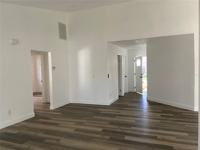 empty room featuring dark hardwood / wood-style flooring