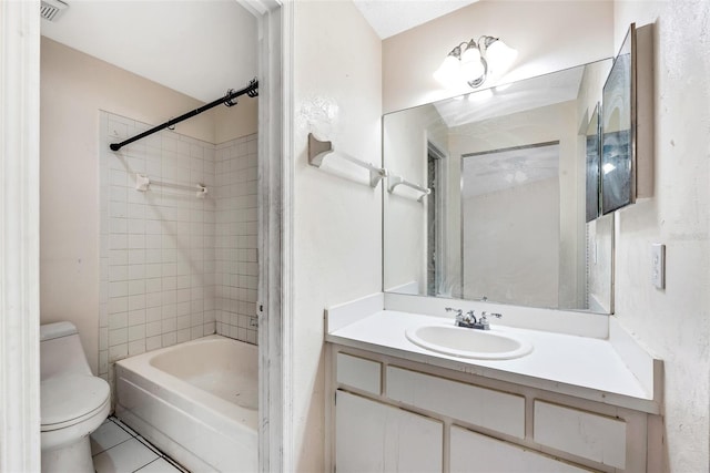 full bathroom with vanity, tile patterned floors, tiled shower / bath combo, and toilet