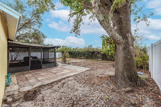 view of yard featuring a sunroom and a patio area