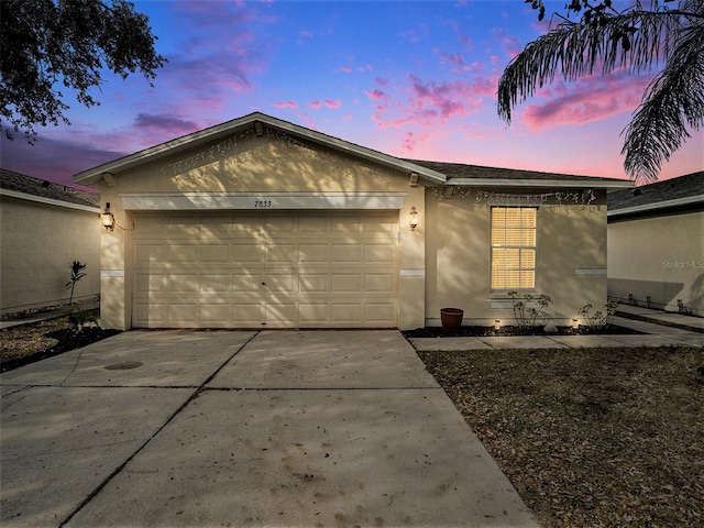 7833 Carriage Pointe Dr, Gibsonton, FL 33534 - single story home featuring stucco siding, a garage, and concrete driveway