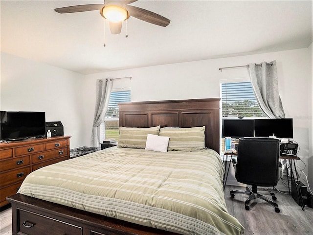 bedroom with light wood finished floors and a ceiling fan