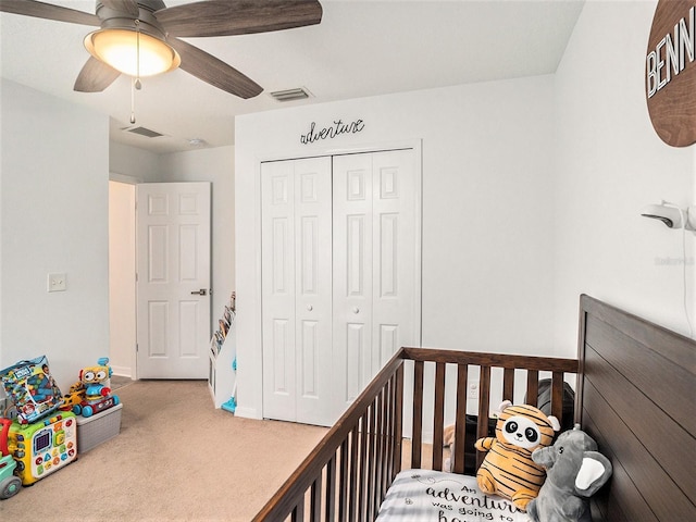 carpeted bedroom with visible vents, a closet, baseboards, and ceiling fan