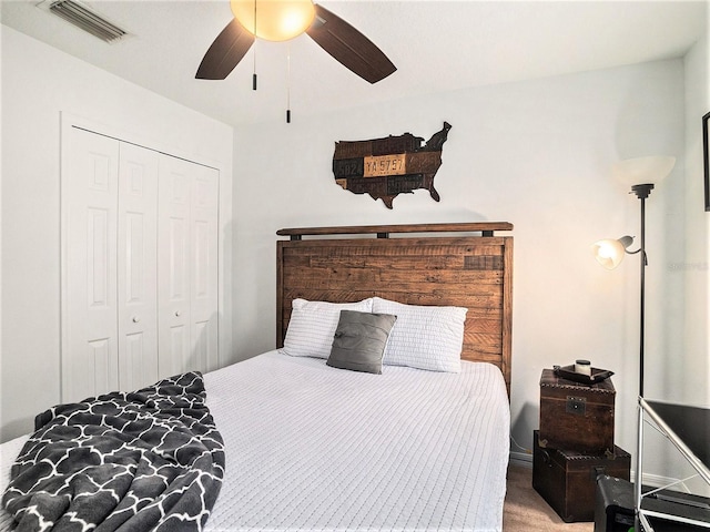 carpeted bedroom featuring visible vents, ceiling fan, and a closet