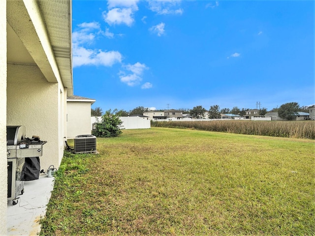 view of yard featuring fence and cooling unit