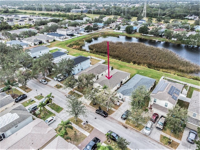 bird's eye view featuring a water view and a residential view