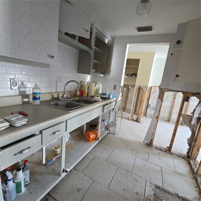 kitchen with tasteful backsplash and sink