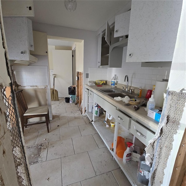 kitchen featuring backsplash and sink