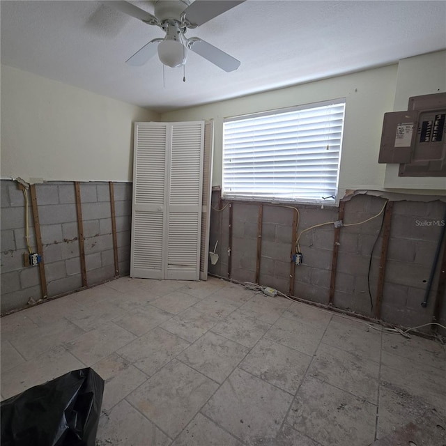 interior space featuring electric panel and ceiling fan