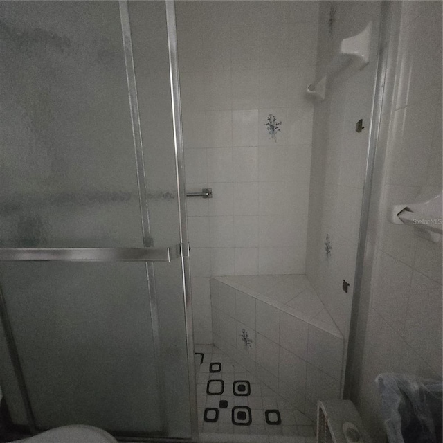 bathroom featuring a shower with door