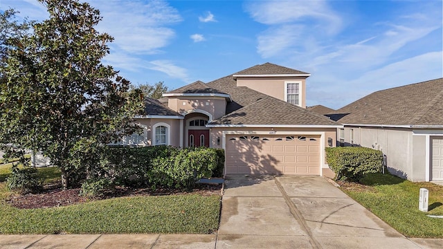 view of front facade featuring a front yard and a garage