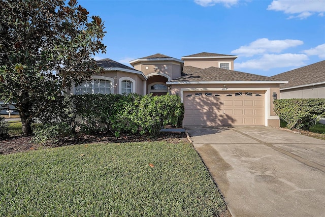 view of front facade with a front yard and a garage