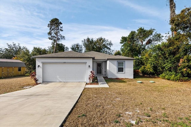 single story home with a garage, a shed, and a front lawn