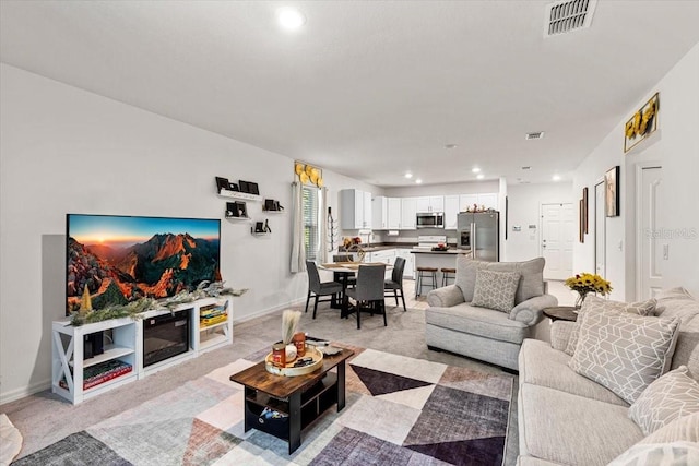 living room featuring light carpet