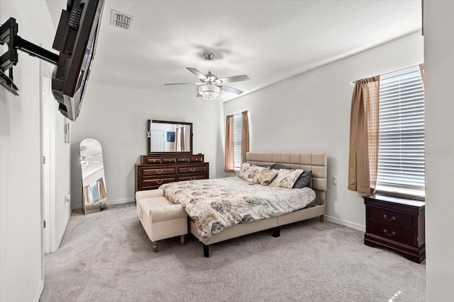 bedroom with ceiling fan and light carpet