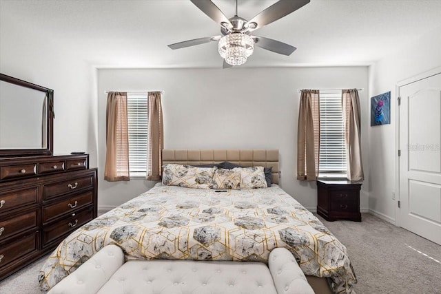 bedroom featuring ceiling fan and light carpet