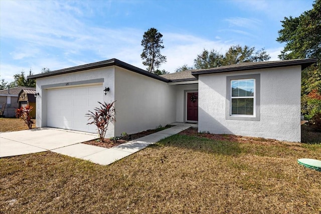 ranch-style house with a garage, a front yard, driveway, and stucco siding