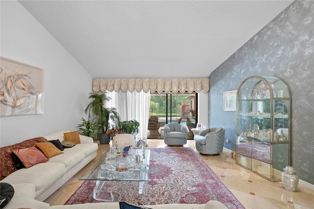 living room with a textured ceiling and vaulted ceiling