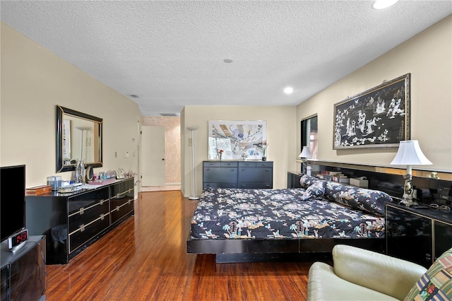 bedroom featuring a textured ceiling and dark wood-type flooring