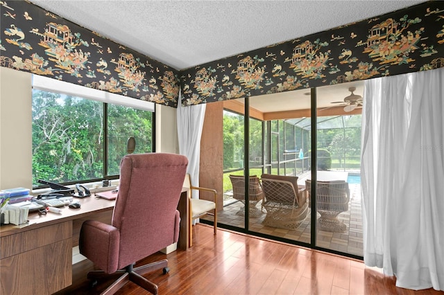 home office featuring a textured ceiling, hardwood / wood-style flooring, and ceiling fan