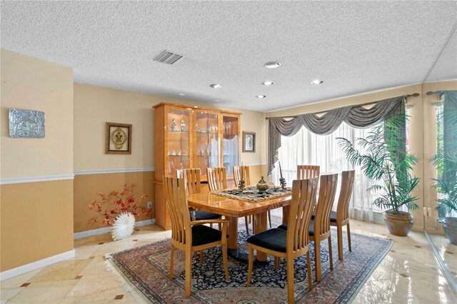 dining area with a textured ceiling