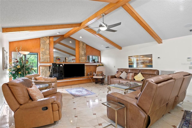 living room featuring vaulted ceiling with beams, ceiling fan, and a textured ceiling