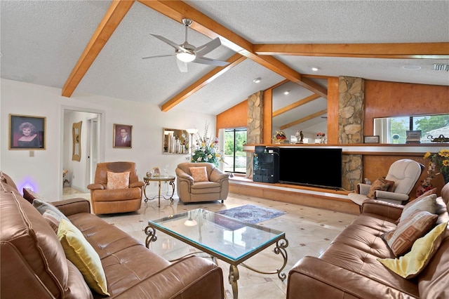 living room with lofted ceiling with beams, ceiling fan, a healthy amount of sunlight, and a textured ceiling