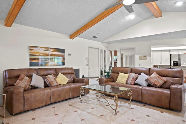 living room featuring ceiling fan, light tile patterned floors, lofted ceiling with beams, and a textured ceiling