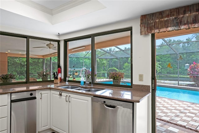 kitchen featuring dishwasher, ceiling fan, white cabinetry, and sink