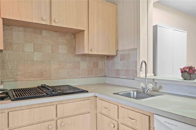 kitchen with light brown cabinetry, decorative backsplash, sink, and white dishwasher