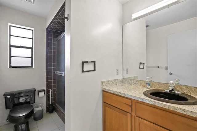 bathroom with tile patterned floors, vanity, toilet, and walk in shower