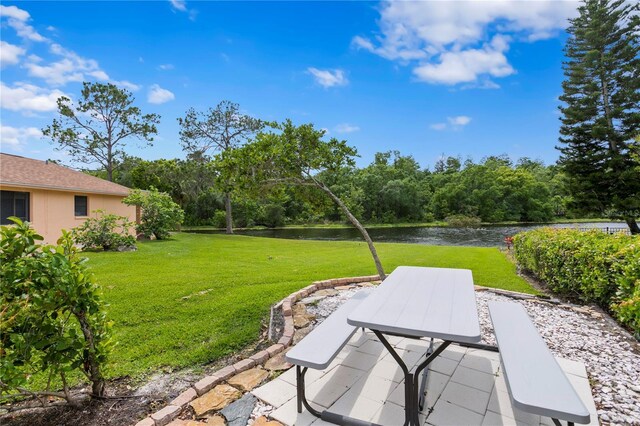 view of yard featuring a water view and a patio