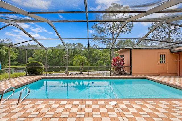 view of swimming pool featuring glass enclosure and a patio