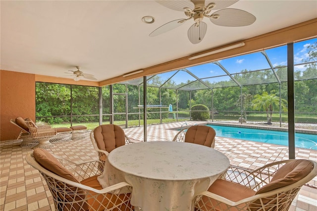 view of pool featuring ceiling fan, a patio area, and a lanai