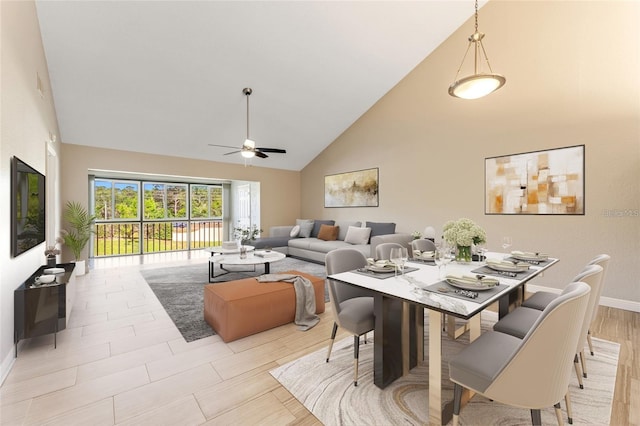 dining space with light wood-type flooring, high vaulted ceiling, and ceiling fan