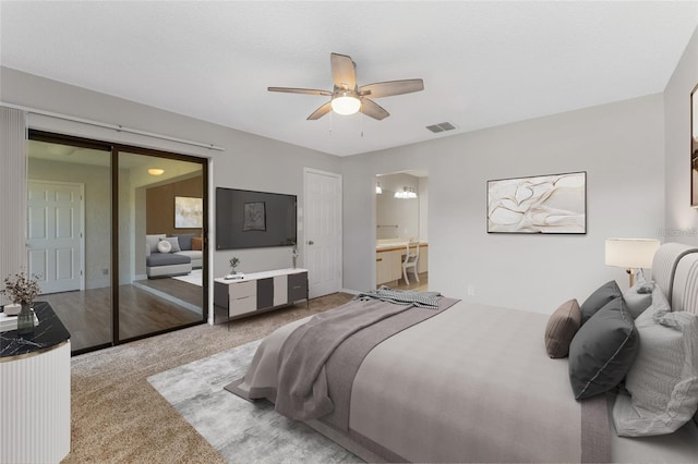 carpeted bedroom featuring connected bathroom, a closet, and ceiling fan