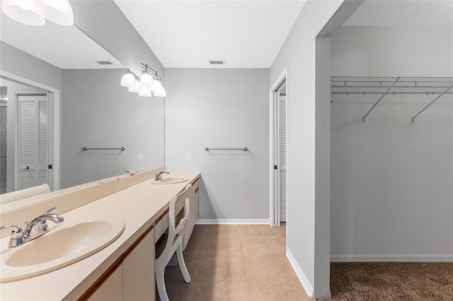 bathroom featuring tile patterned floors and vanity