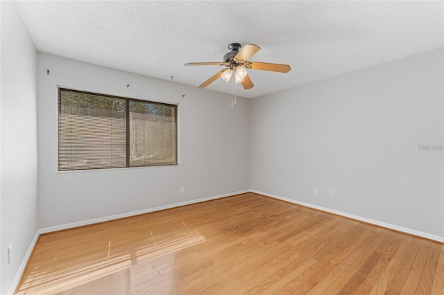 unfurnished room with a textured ceiling, hardwood / wood-style flooring, and ceiling fan