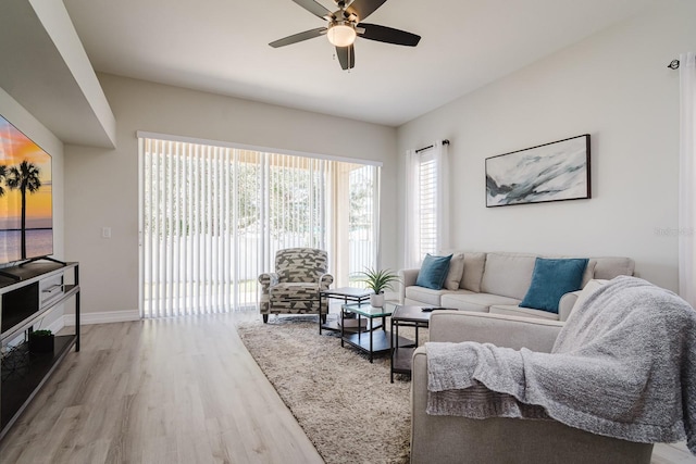 living room with hardwood / wood-style floors and ceiling fan