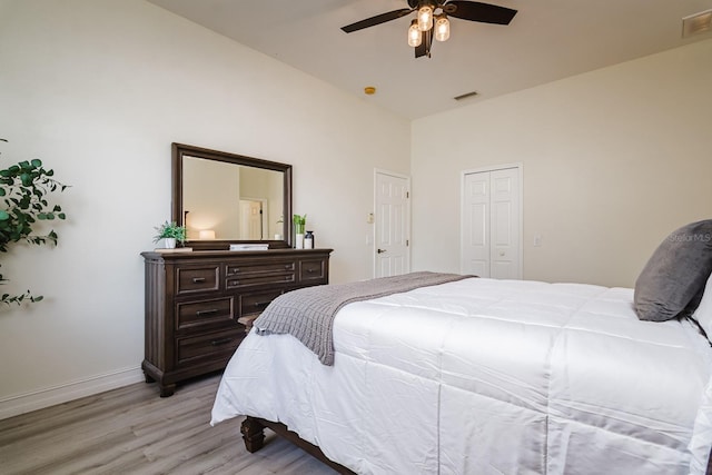 bedroom with ceiling fan, light wood-type flooring, and vaulted ceiling